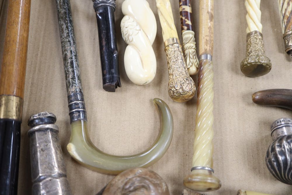 A group of silver, gilt metal and ivory walking cane and parasol handles.